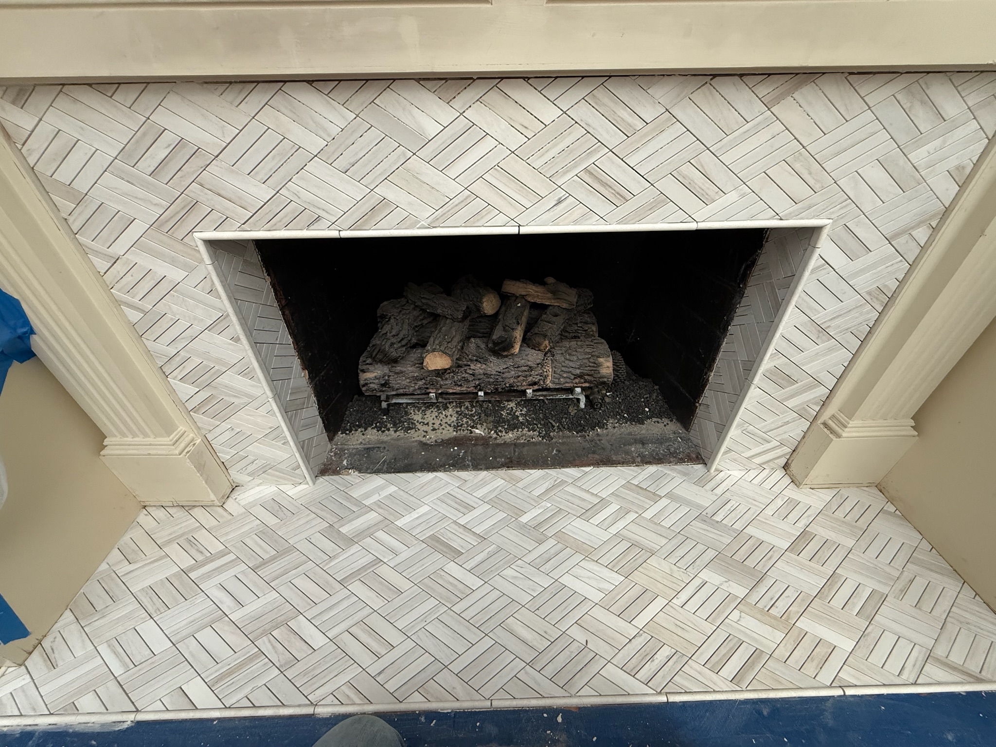 After: light herringbone tile fireplace surround and hearth in Upstate, SC - Bittner family fireplace remodel