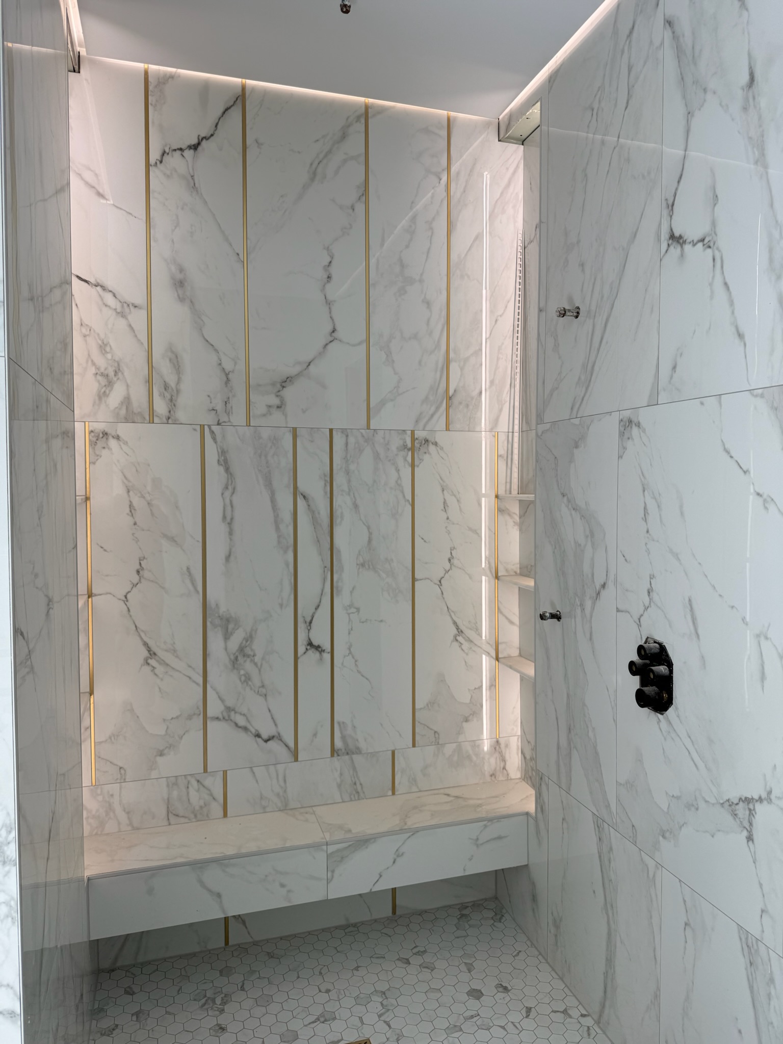 Calacatta gold walk-in shower with built-in bench in Upstate SC